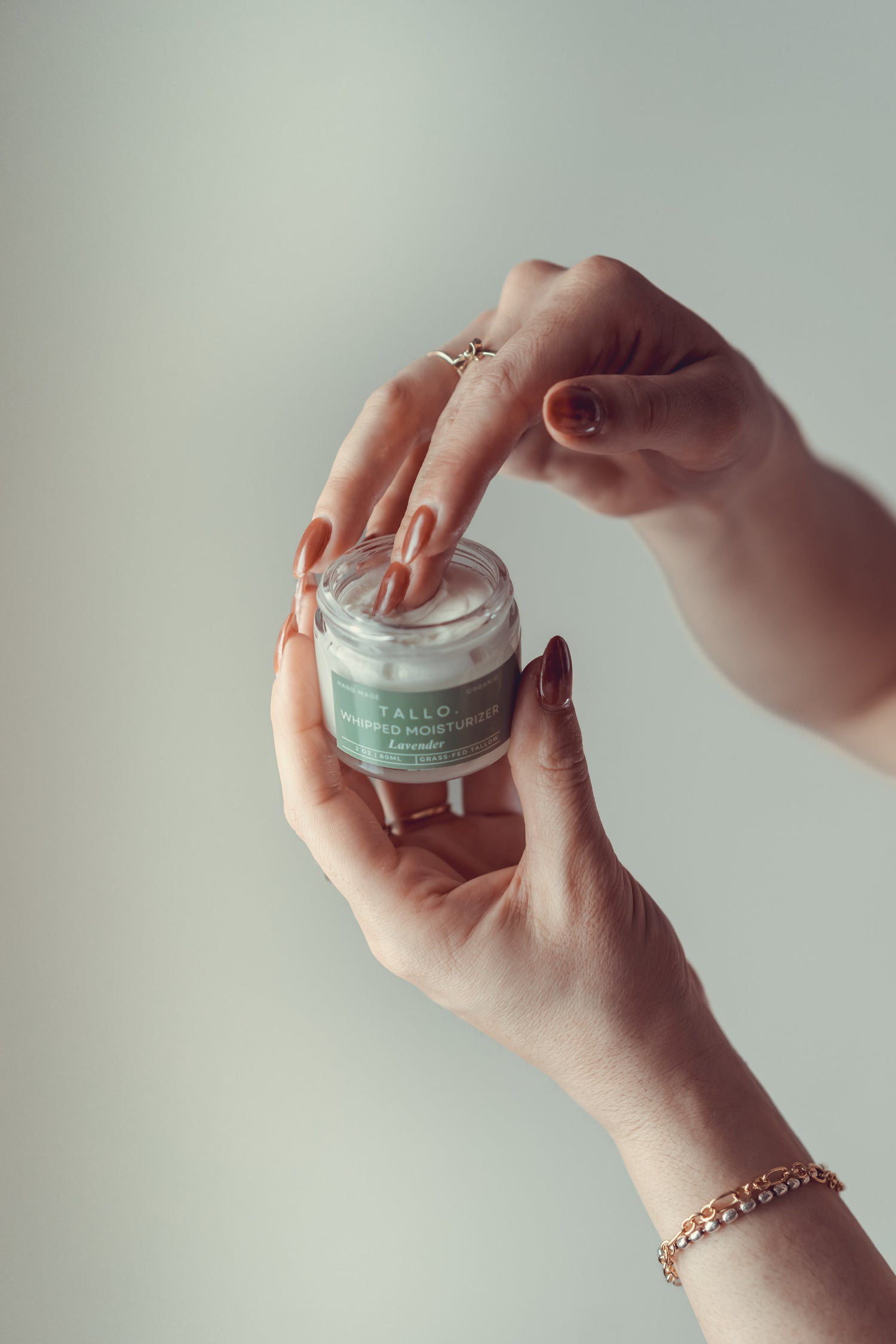 hand in whipped tallow jar green label