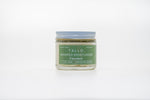 A closed 2 oz glass jar of Tallo Unscented Whipped Moisturizer. The jar describes the size, ingredients, and handmade nature of the skincare.