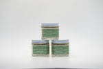 A set of three small glass jars of Tallo Whipped Moisturizer with green labels and white lids, stacked in a pyramid formation. The labels read Frankincense. The product is labeled as handmade, organic, and made with grass-fed tallow.